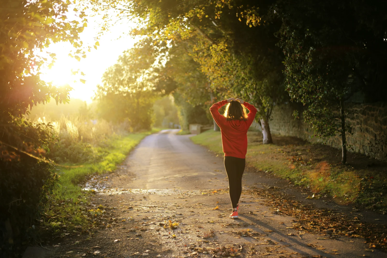 Person practicing mindfulness during a quiet walk as part of a daily meditation routine