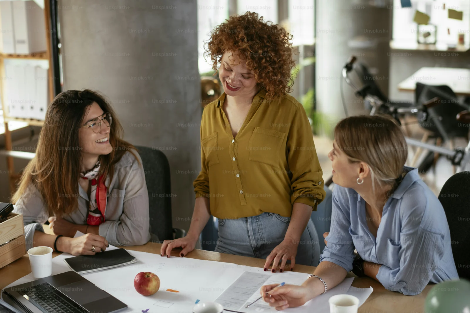 Professional experiencing imposter syndrome at work while sitting in an office meeting