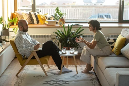 Two people in a serious conversation illustrating codependency patterns in a close relationship