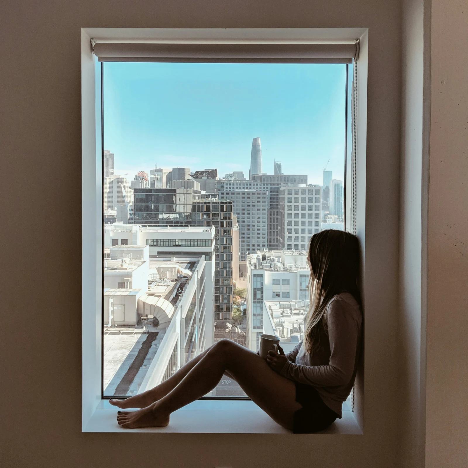 Person sitting quietly by a window reflecting on grief and personal growth after loss