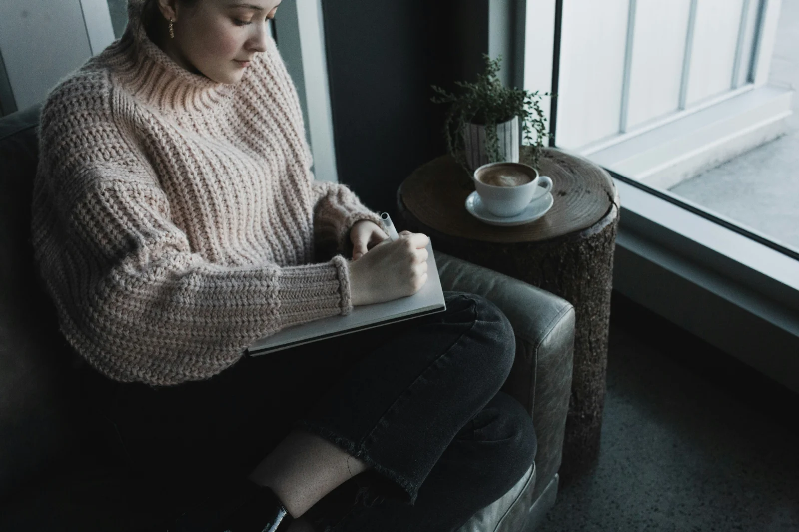 Person using a journal as a personality test for growth and deeper self-reflection.