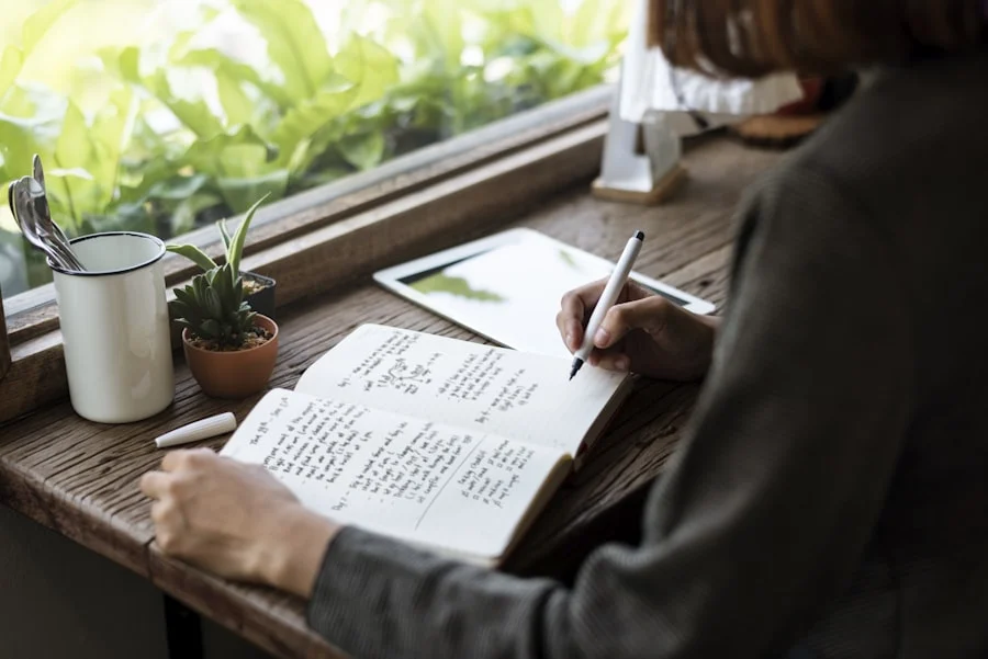 Person journaling during a quiet morning while reflecting on growth after loss