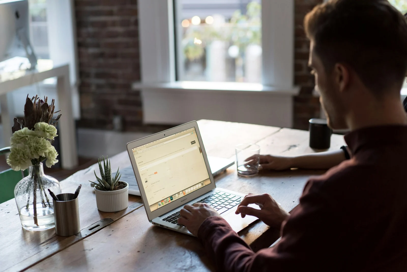 Entrepreneur using online networking strategies from a laptop instead of attending an in-person event