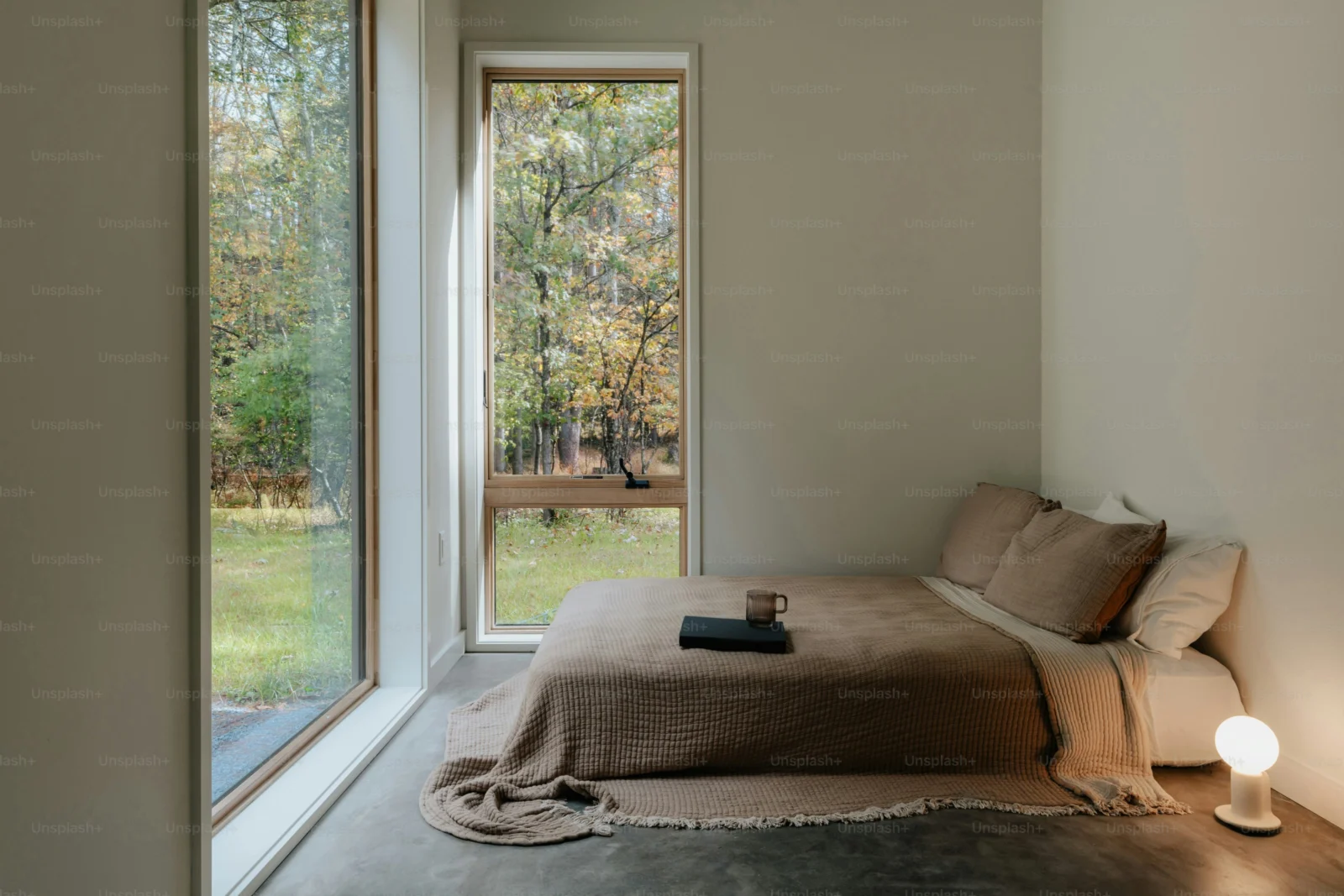 Calm bedroom setup for sleep with simple bedding, dark curtains, and an uncluttered nightstand