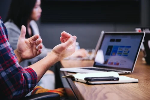 Manager delivering constructive feedback to employee during private one-on-one meeting