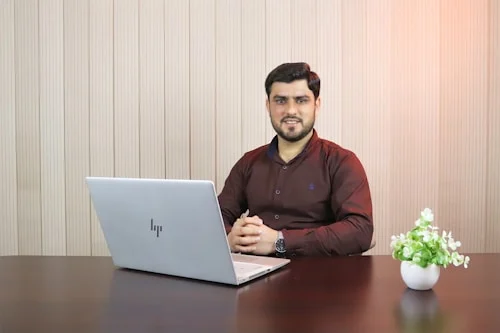 Professional showing signs their career stalled, staring at laptop in office
