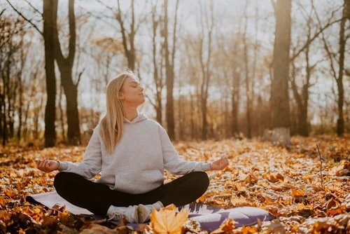 Person practicing emotional regulation through quiet mindfulness and reflection