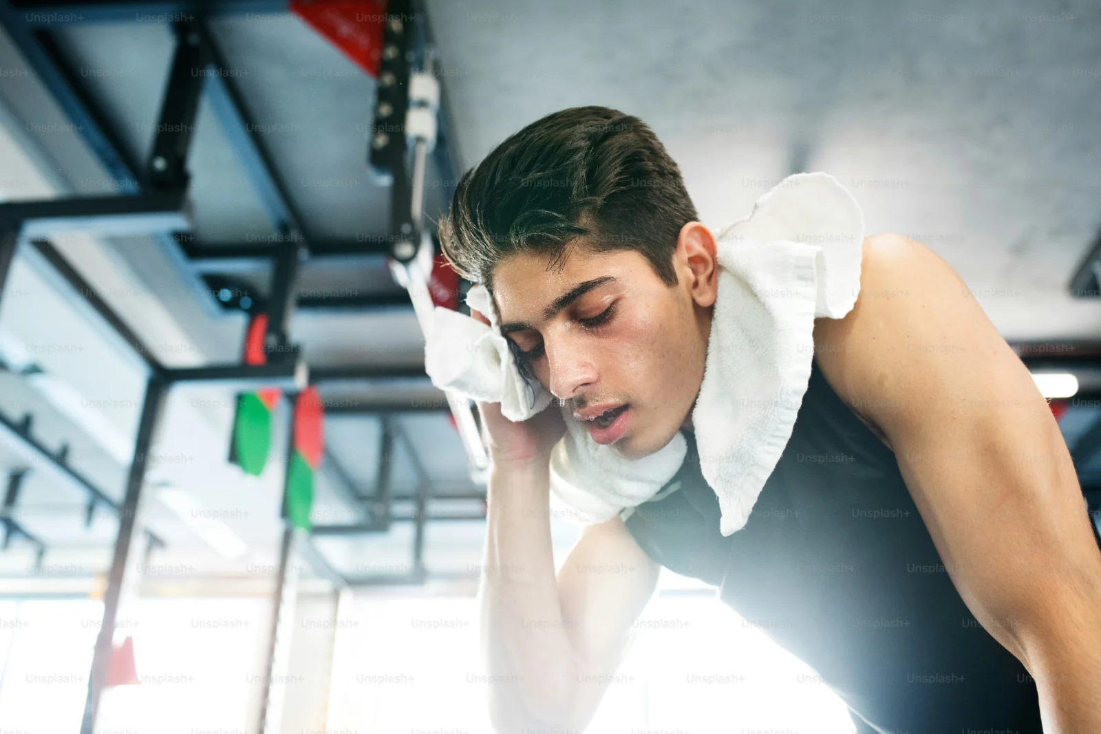 Tired athlete resting after a workout while noticing possible overtraining signs