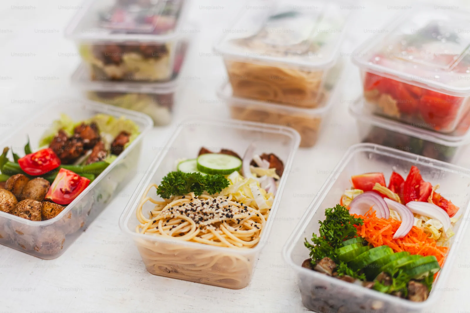 Sunday meal prepping with vegetables, grains, and protein portioned into containers