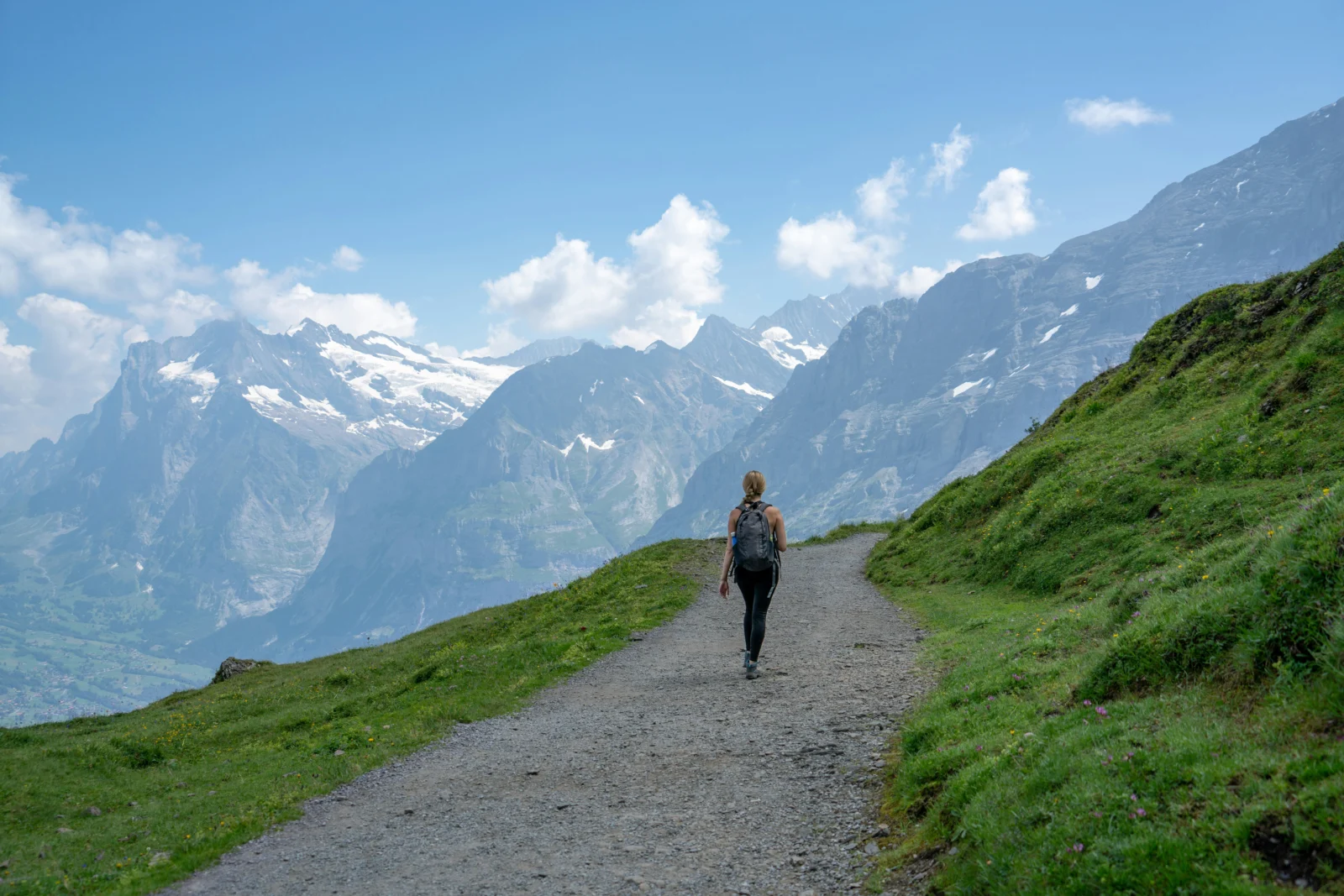Woman practicing walking meditation on a quiet tree-lined path